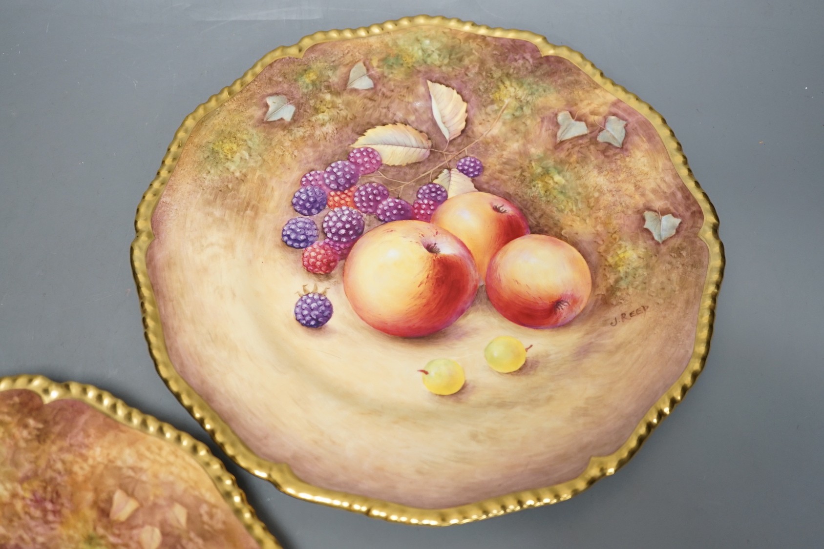A pair of Royal Worcester fruit painted dinner plates, post war, by J. Reed, 27cm diameter